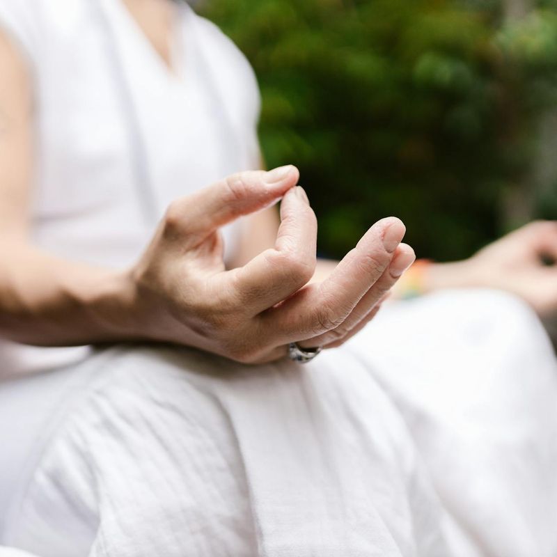 Close-up of hands in a meditative mudra position