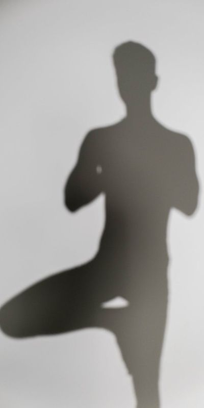 Silhouette of a person performing a balance yoga pose